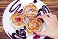 Woman`s hand take one of three apple muffins