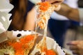 Woman`s hand take pizza pices out from pizza plate in foodtruck event, Cheese`s pizza is stretced by her