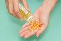 Woman's hand take vitamin Omega-3 fish oil pills Royalty Free Stock Photo