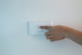 Woman`s hand is turning off the light switch on wall Royalty Free Stock Photo