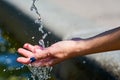 WomanÃÂ´s hand under a fresh stream of water.