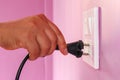 The woman`s hand, unplug or pull the electric plug. Royalty Free Stock Photo