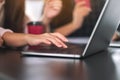 A woman`s hand using and typing on laptop computer keyboard on the table Royalty Free Stock Photo