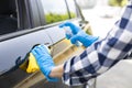 Woman`s hand wearing gloves and spraying disinfectant car Royalty Free Stock Photo