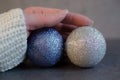 Woman`s hand holding christmas balls Royalty Free Stock Photo