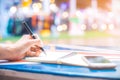 Woman`s hand writing on a notebook with a pen on a wooden desk. Royalty Free Stock Photo