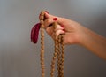 A woman`s hande holding rudraksha beads rosary on the blue background with copy space Royalty Free Stock Photo