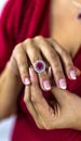 Woman`s hands adjusting a luxurious ring with precious stones and silver. Ring with brilliant rubies Royalty Free Stock Photo