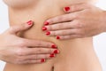 Woman's hands on belly on white background