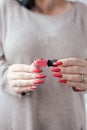 Woman`s hands and a bottle of red orange nail polish Royalty Free Stock Photo