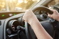 Woman`s hands on car steering wheel