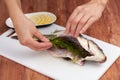 Woman's hands carving a carp