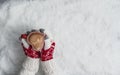 Woman`s hands in Christmas knitted gloves with a cup of coffee in the form of heart on snow. New Year, Christmas and winter conce