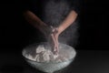 Woman`s hands clapping with flour on a black background Royalty Free Stock Photo