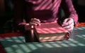 Woman`s hands on a closed bible on a table Royalty Free Stock Photo