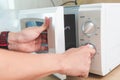 Woman`s Hands Closing Microwave Oven Door And Preparing Food in microwave Royalty Free Stock Photo