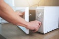 Woman`s Hands Closing Microwave Oven Door And Preparing Food in microwave Royalty Free Stock Photo