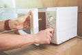 Woman`s Hands Closing Microwave Oven Door And Preparing Food in microwave Royalty Free Stock Photo