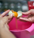 Woman`s hands cracking eggs Royalty Free Stock Photo