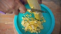 A woman\'s hands cut and thresh corn from the cobs using a sharp knife