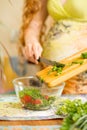 Woman s hands cutting fresh onions, dill, parsley on kitchen Focus on green vegetables Royalty Free Stock Photo