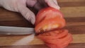 Woman's hands cutting mushroom tomato