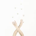 Woman`s hands dance in harmony with some origami butterflies, fantasy concept