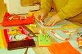 Woman`s hands drawing a pattern on bright material at her workpl