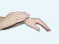 A woman`s hands, a drop of white moisturizer on her arm. Hand care, skin hydration