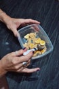 woman's hands eating sliced banana with Peruvian maca