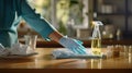 a woman& x27;s hands engaged in the cleaning process, with the tabletop gleaming after being polished. The composition Royalty Free Stock Photo