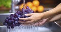 A Woman\'s Hands Gently Washing Fresh Grapes Under Flowing Water Royalty Free Stock Photo