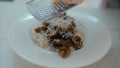 Woman's hands grating parmesan cheese ov