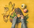 Woman` s hands in grey woolen sweater holding cup of espresso Royalty Free Stock Photo