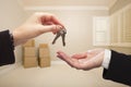 Woman's Hands Handing Over the House Keys Inside Empty Tan Room