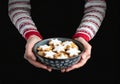 Woman\'s hands hold a bowl with delicious cookies. Christmas time. AI generative