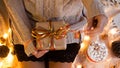 Woman`s hands hold christmas or new year decorated gift box. New Year`s concept.selective focus Royalty Free Stock Photo