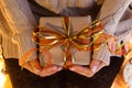 Woman`s hands hold christmas or new year decorated gift box. New Year`s concept.selective focus Royalty Free Stock Photo