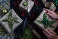 Woman`s hands hold Christmas or New Year decorated gift box. Royalty Free Stock Photo