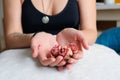 A woman`s hands hold dry pink flowers on a white pillow. A woman`s body is in the background. A picture about femininity, the Royalty Free Stock Photo