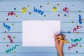 Woman`s hands hold pen and writing on white blank paper with colorful ribbons around Royalty Free Stock Photo