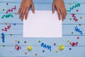 Woman`s hands hold pen and writing on white blank paper with colorful ribbons around Royalty Free Stock Photo