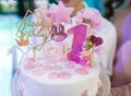 Woman`s hands hold White birthday cream cake with pink candles as decorations. Celebration, festive background, birthday party Royalty Free Stock Photo