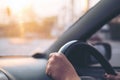 Woman`s hands holding on black steering wheel while driving a car Royalty Free Stock Photo