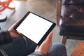 Woman`s hands holding black tablet pc with blank screen horizontally in cafe Royalty Free Stock Photo