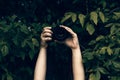 Woman`s hands holding camera and snapping photos Royalty Free Stock Photo