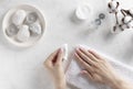 Woman`s hands holding a cotton pad and removing pink nail polish. Royalty Free Stock Photo