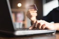 Woman`s hands holding credit card and typing on the keyboard of laptop for shopping online. Pays for purchase Royalty Free Stock Photo