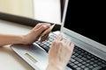 Woman`s hands holding a credit card and using laptop for online shopping Royalty Free Stock Photo