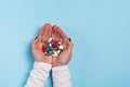 Woman`s hands holding a different tablets and pills over blue Royalty Free Stock Photo